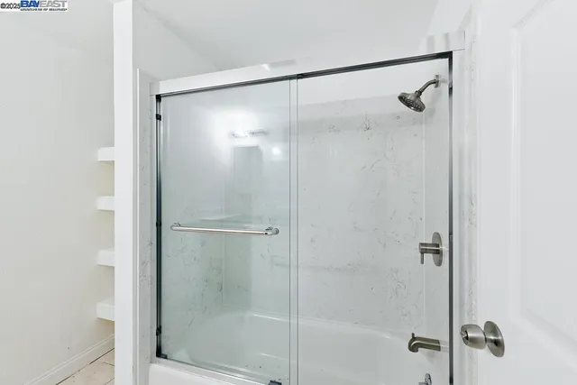 a view of a white building among the street with palm trees