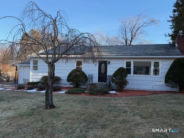 a view of a house with backyard and a tree