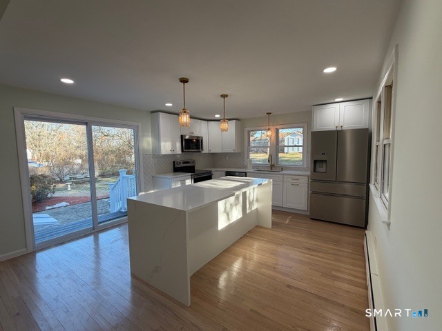 26 Kelly Road Hamden, CT 06518 - Photo 13 of 38 a large kitchen with stainless steel appliances a large counter top a stove a sink and a refrigerator
