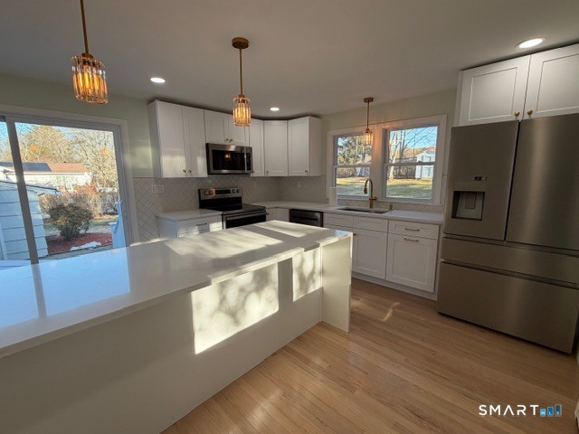 26 Kelly Road Hamden, CT 06518 - Photo 14 of 38 a kitchen with stainless steel appliances granite countertop a refrigerator a stove a sink and a refrigerator