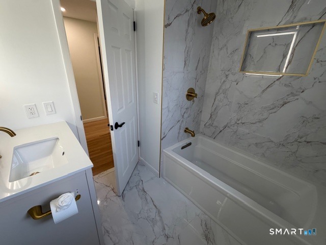 26 Kelly Road Hamden, CT 06518 - Photo 21 of 38 a bathroom with a tub and a shower