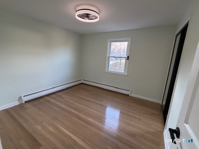 26 Kelly Road Hamden, CT 06518 - Photo 22 of 38 an empty room with wooden floor and windows