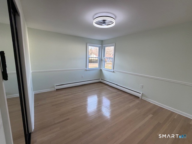 26 Kelly Road Hamden, CT 06518 - Photo 24 of 38 an empty room with wooden floor and windows