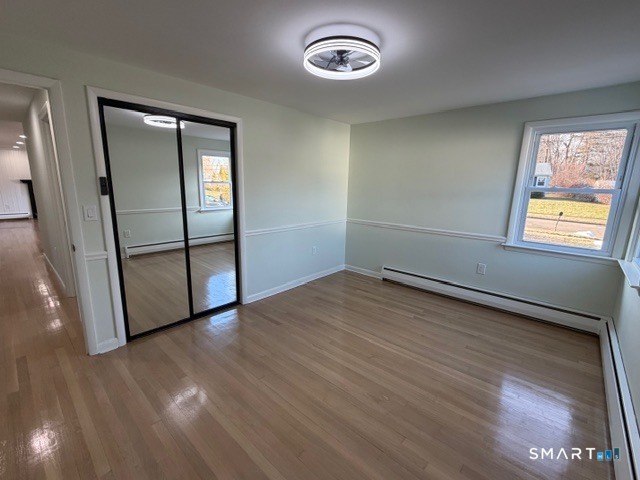26 Kelly Road Hamden, CT 06518 - Photo 25 of 38 an empty room with wooden floor and windows