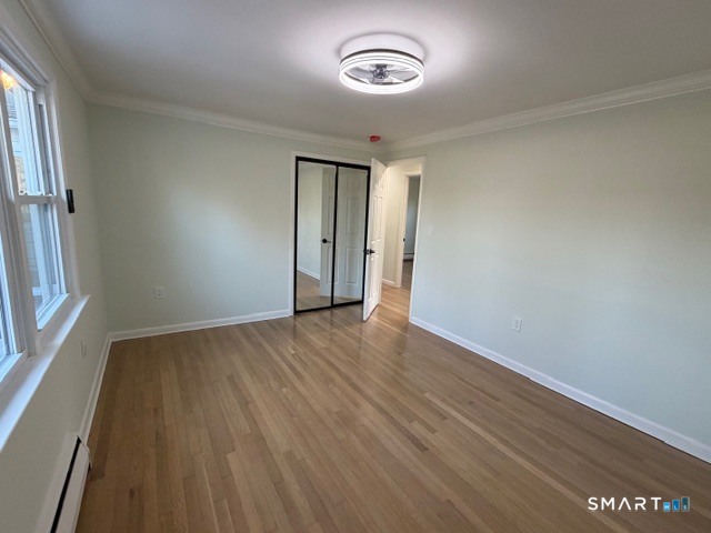 26 Kelly Road Hamden, CT 06518 - Photo 26 of 38 an empty room with wooden floor and windows