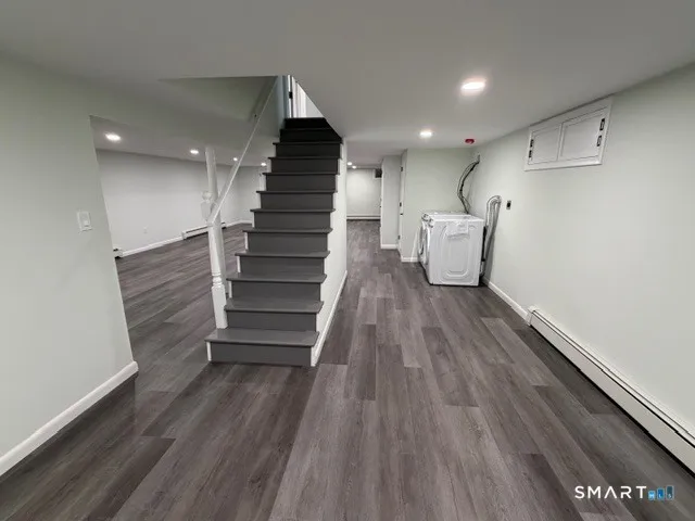 a view of entryway and hall with wooden floor