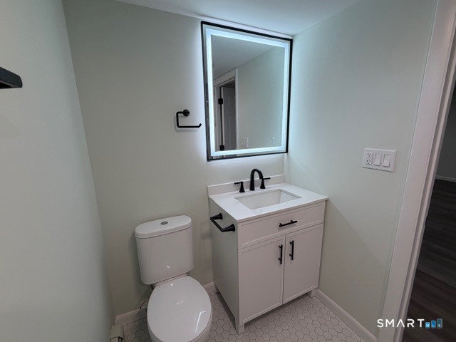 26 Kelly Road Hamden, CT 06518 - Photo 33 of 38 a bathroom with a toilet sink and mirror