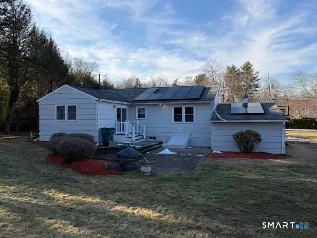 a view of a house with a yard and a garden