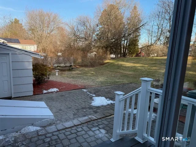 a view of a wooden deck besides a house