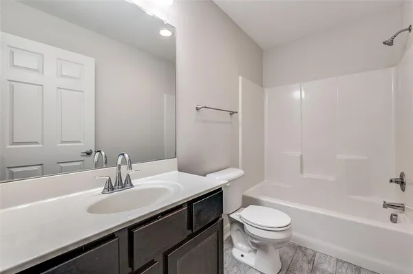 a bathroom with a sink a toilet and a bathtub