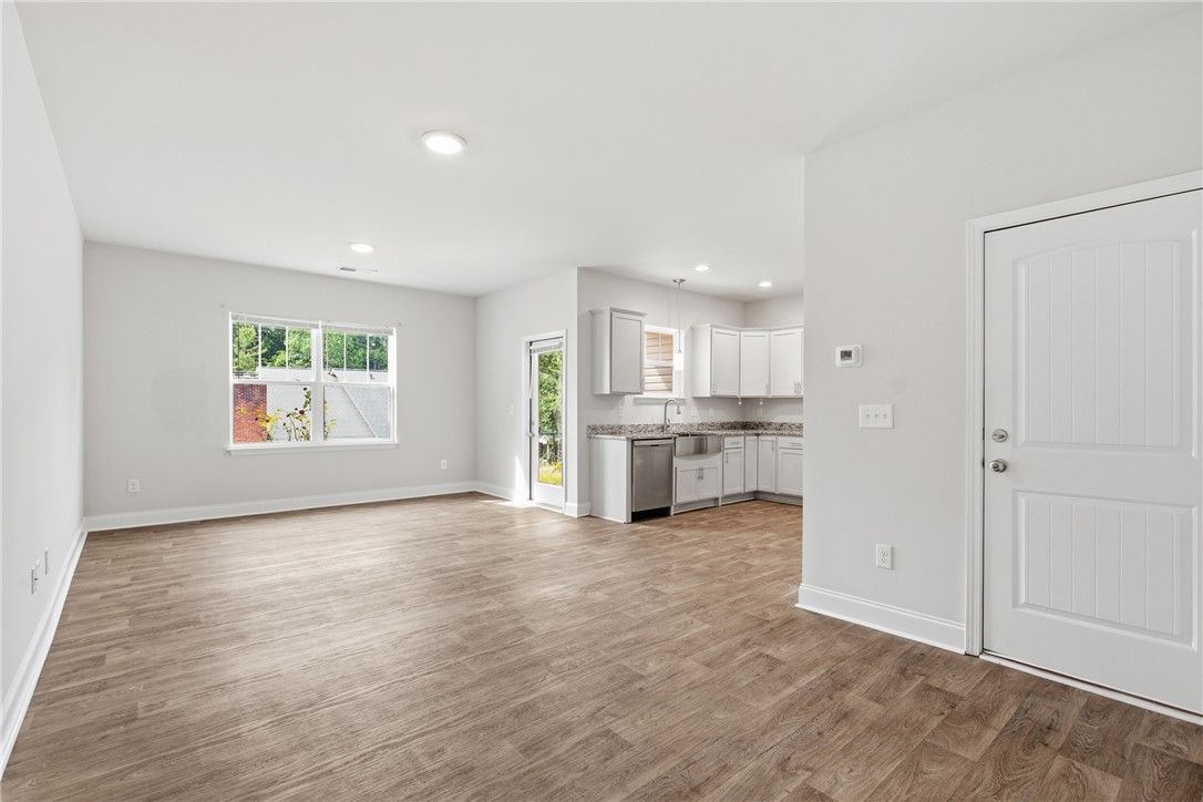 116 Ventura Street Anderson, SC 29621 - Photo 4 of 27 Gleaming wood-look floors unite this airy open layout connecting the main living area and kitchen.