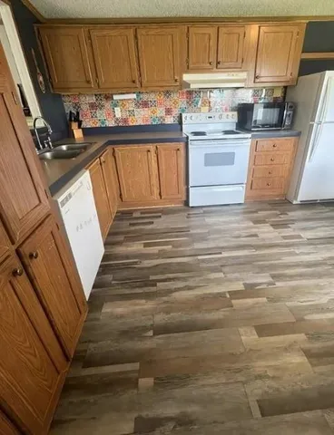 a kitchen with cabinets and appliances