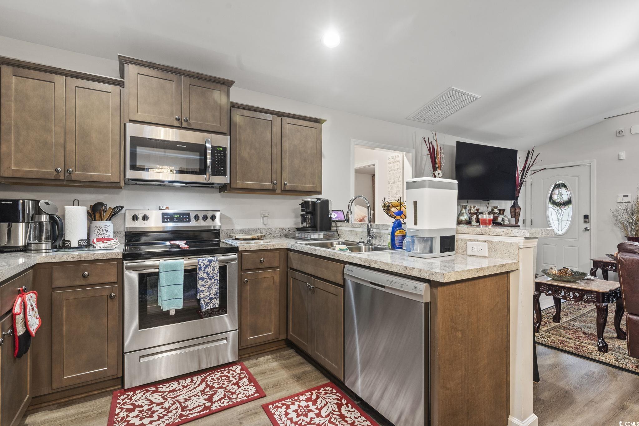 3500 Church Street Loris, SC 29569 - Photo 14 of 30 Kitchen with dark brown cabinetry, appliances with