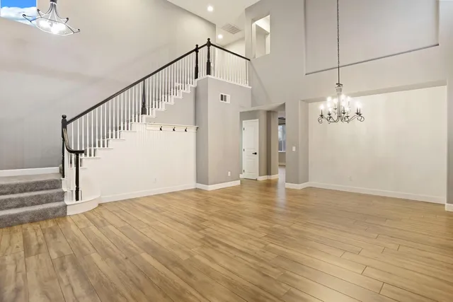 a view of a room with wooden floor and staircase