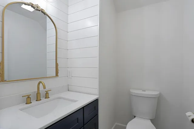 a bathroom with a toilet sink and mirror