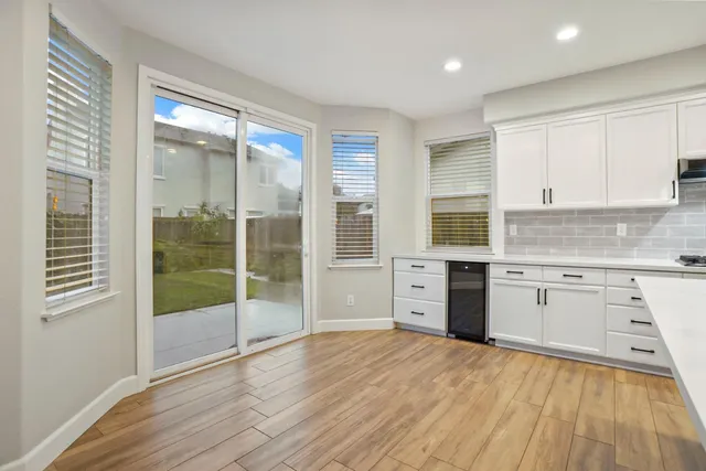 a kitchen with stainless steel appliances a sink cabinets and wooden floor