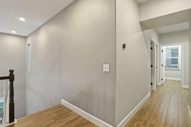 an empty room with a window and a ceiling fan