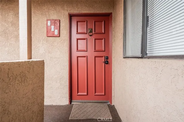 a view of an empty room with a fireplace and wooden floor