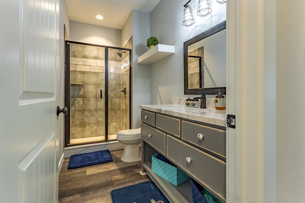 14910 Old Stoney Road Ponder, TX 76259 - Photo 23 of 36 a bathroom with a toilet a sink and mirror