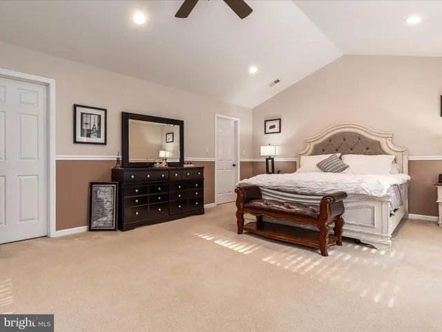 a bathroom with a tub a sink and a large mirror