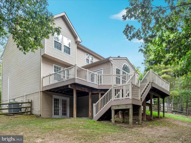 a view of a field with a trees in the background