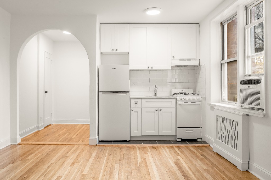 5645 Netherland Avenue, Unit 2F Bronx, NY 10471 - Photo 1 of 12 a kitchen with white cabinets and white appliances