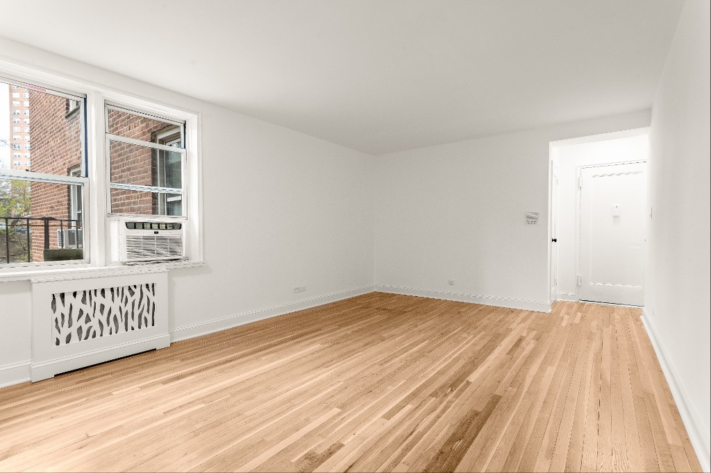 5645 Netherland Avenue, Unit 2F Bronx, NY 10471 - Photo 6 of 12 a view of an empty room with wooden floor and a window