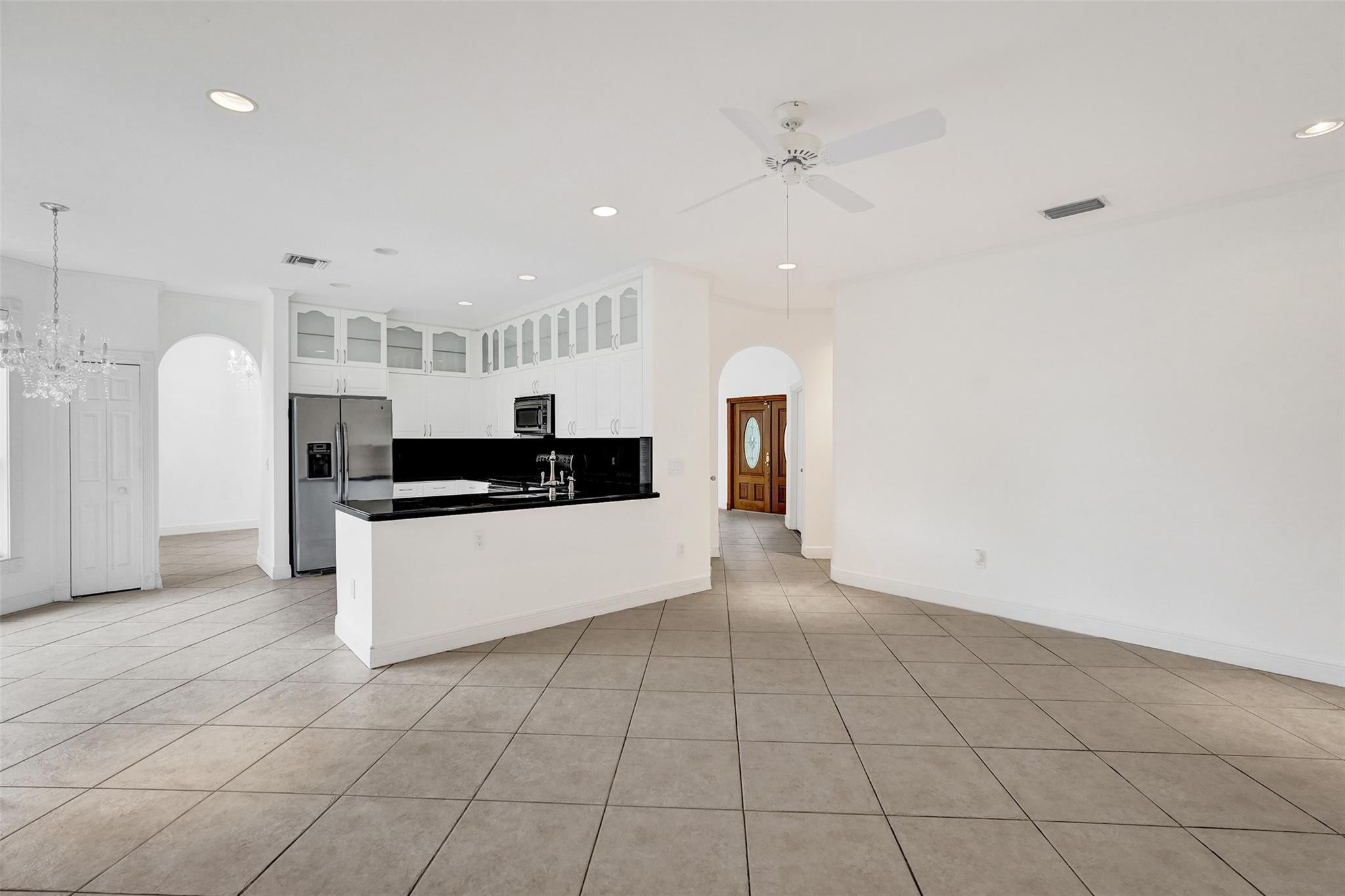 10902 Tamoron Lane Boca Raton, FL 33498 - Photo 13 of 66 a large white kitchen with a sink and cabinets