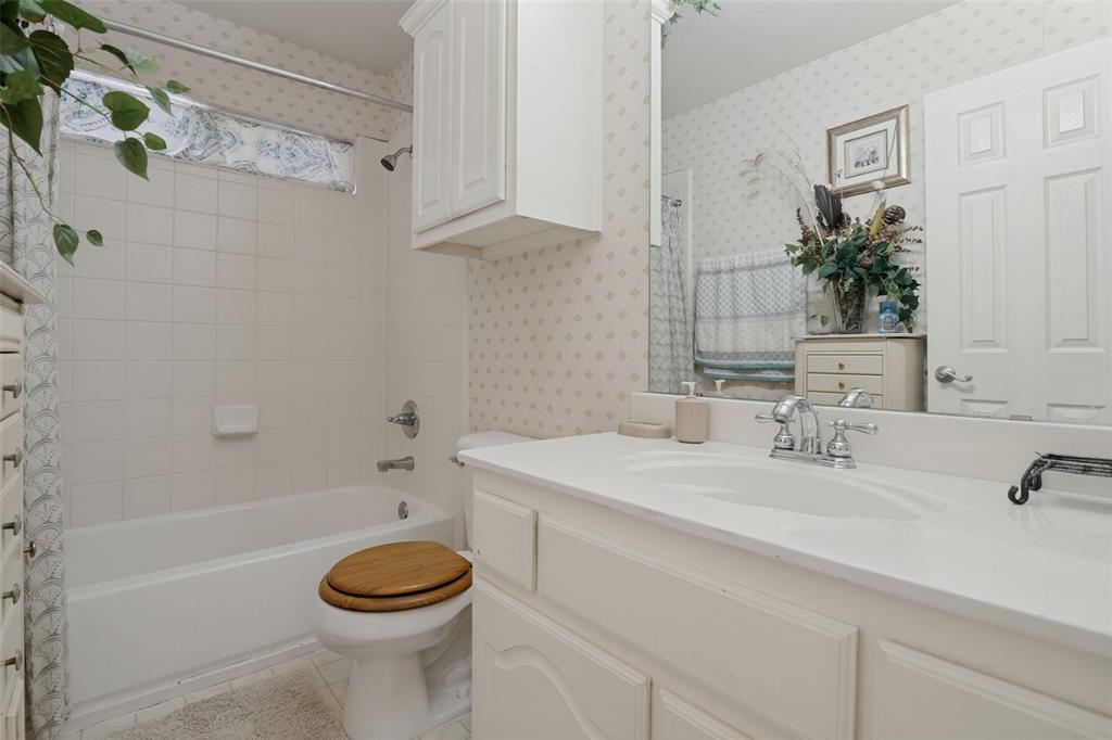 2213 Ranch Road Sachse, TX 75048 - Photo 18 of 28 Vanity with integrated sink, white cabinetry, and wall-mounted mirror
