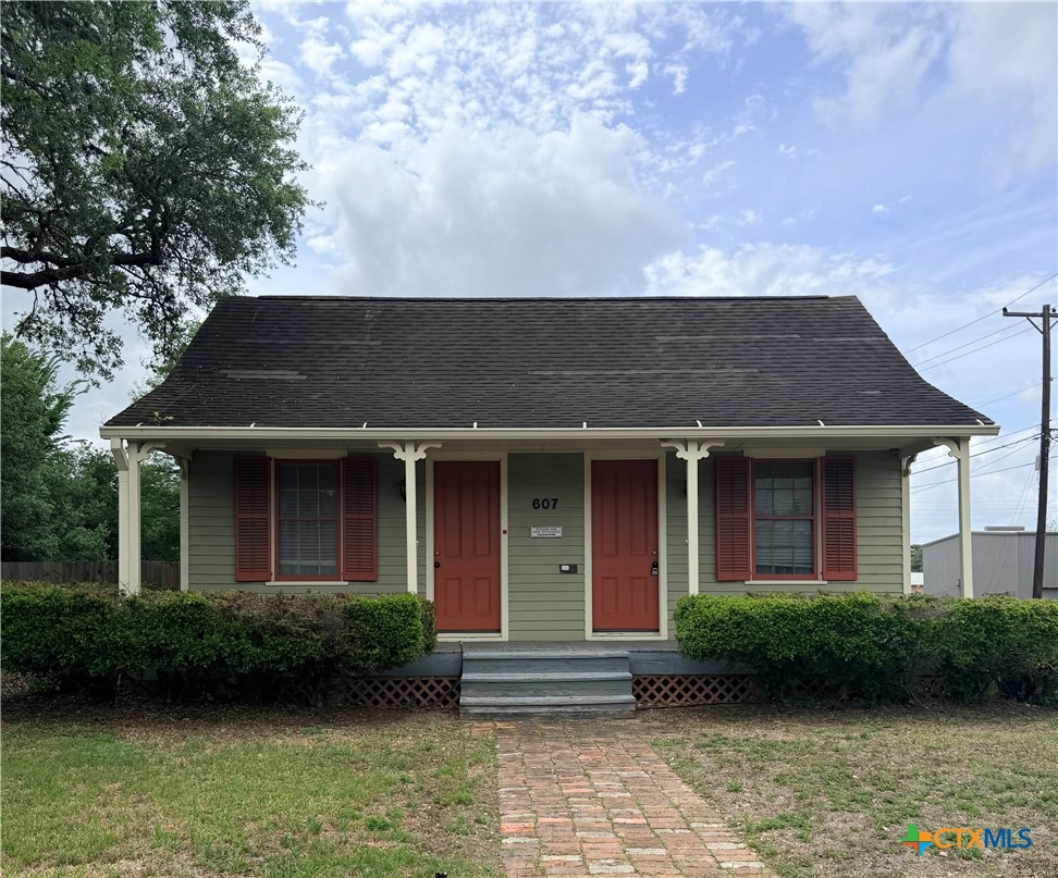 a front view of a house with a garden