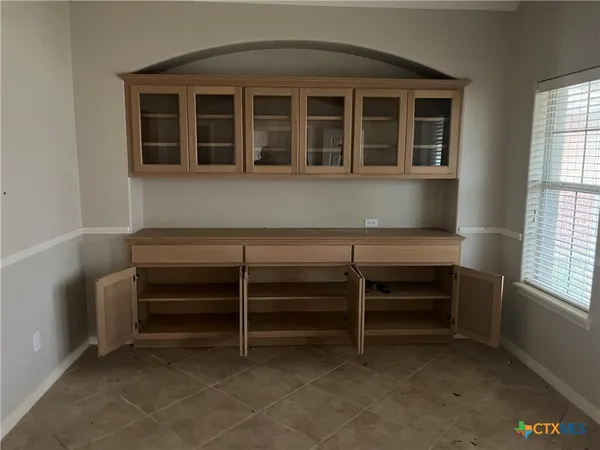 a view of room with a window and a kitchen