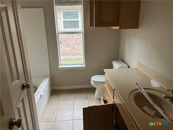 a bathroom with a sink a toilet and a shower