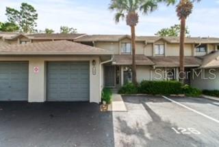 Undisclosed Address Longwood, FL 32779 - Photo 1 of 1 a front view of a house with a garden and palm trees