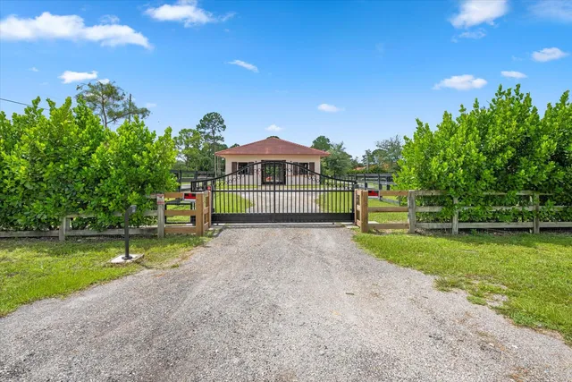 a view of a house with a yard and sitting area