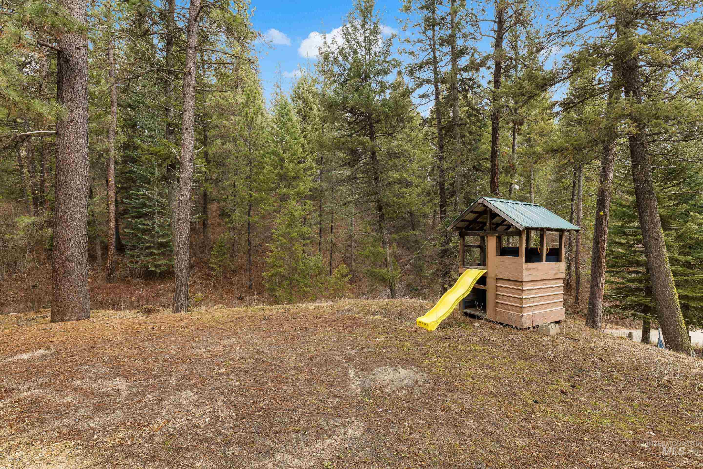 32 Sky Ridge Drive Garden Valley, ID 83622 - Photo 35 of 37 View of yard featuring a playground and a forest view