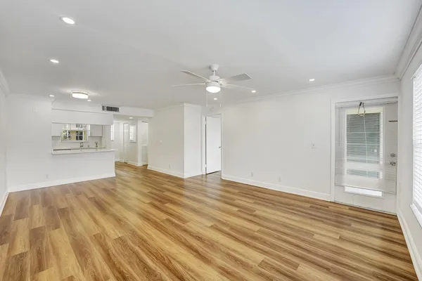 a view of a kitchen with a sink and wooden floor