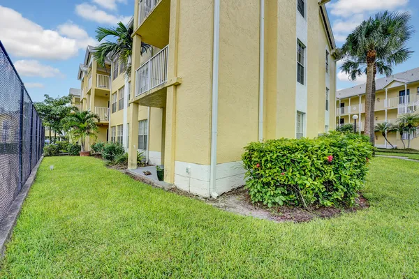 a view of a apartment building and a big yard