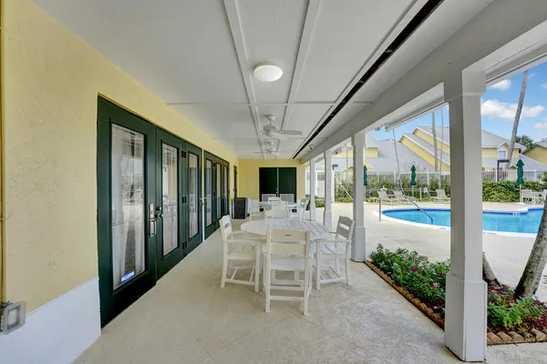 a swimming pool with outdoor seating and yard