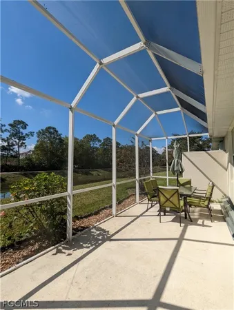 a view of an chairs and table in the patio