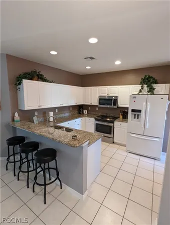 a kitchen with stainless steel appliances granite countertop a sink and cabinets
