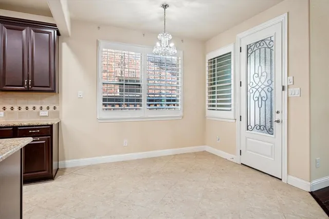 a view of an empty room with a fireplace and a window