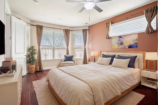 a bedroom with a large bed and a window