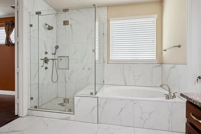 a bathroom with a bathtub and shower