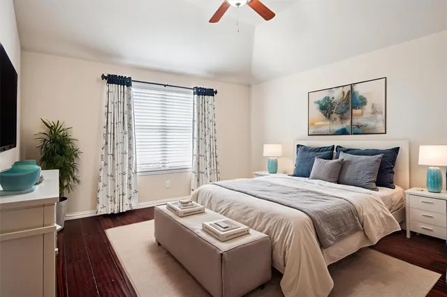 a bedroom with bed and a potted plant