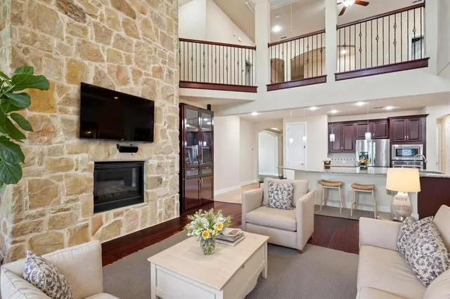 a living room with furniture a flat screen tv and a fireplace