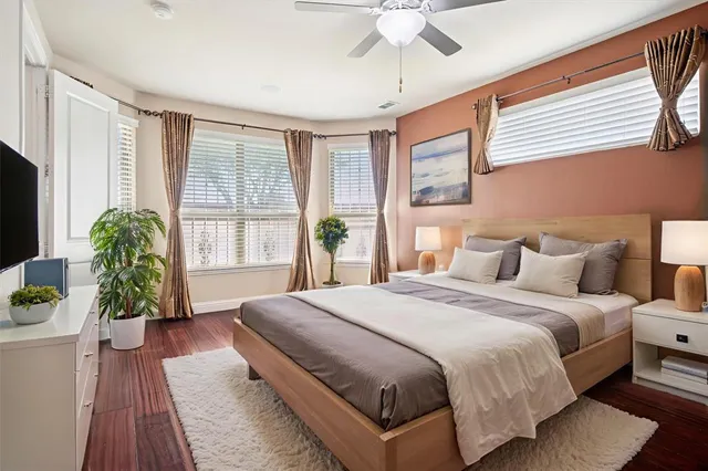 a spacious bedroom with a large bed and a potted plant