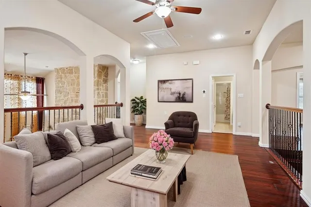 a living room with furniture and a wooden floor