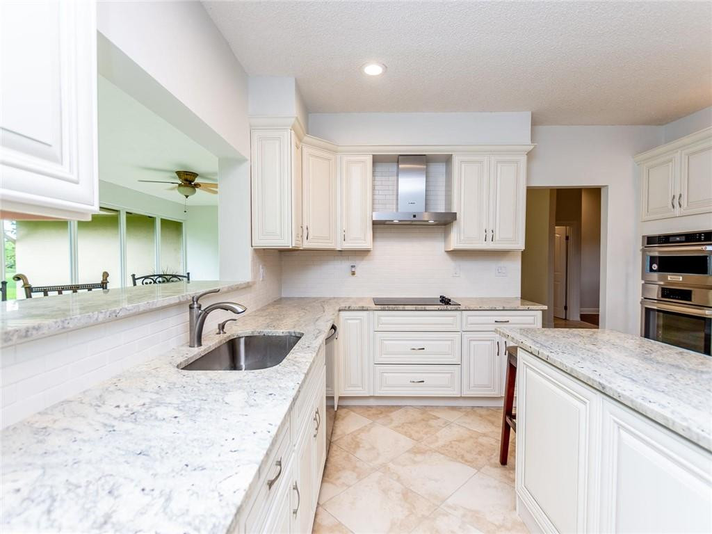 5520 Southwest 166th Avenue Southwest Ranches, FL 33331 - Photo 11 of 50 a kitchen with granite countertop a sink stove and cabinets