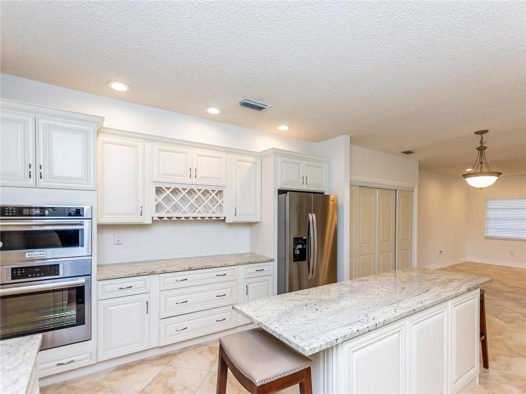 5520 Southwest 166th Avenue Southwest Ranches, FL 33331 - Photo 13 of 50 a kitchen with refrigerator cabinets and wooden floor