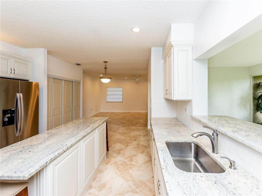 5520 Southwest 166th Avenue Southwest Ranches, FL 33331 - Photo 14 of 50 a kitchen with granite countertop a sink a counter top space appliances and cabinets